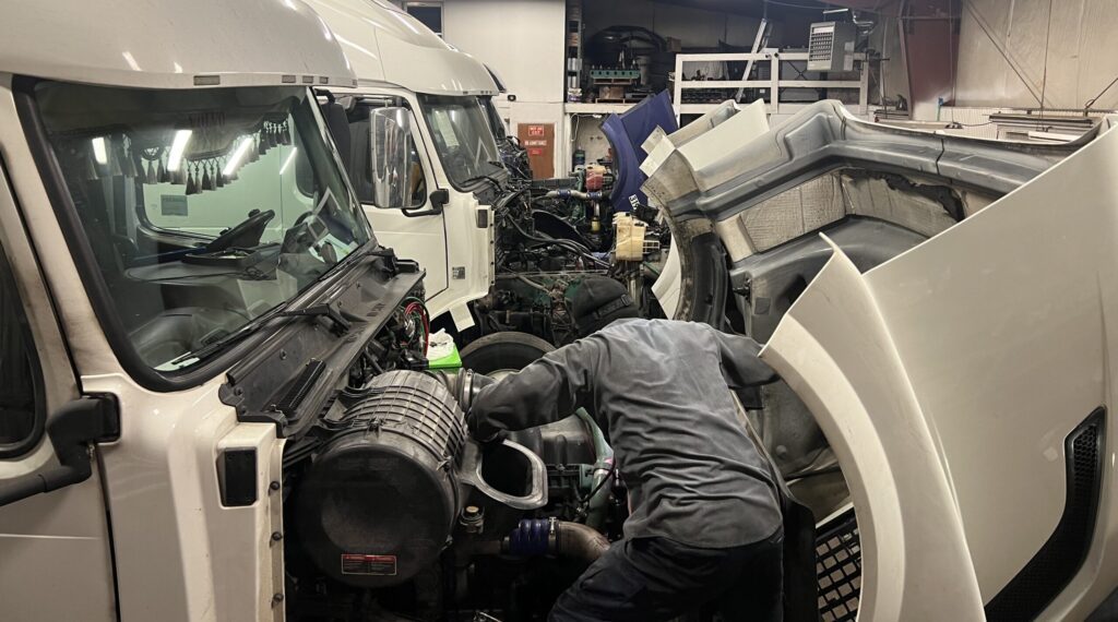  vnl truck repair Mechanic repairing Volvo VNL engine.