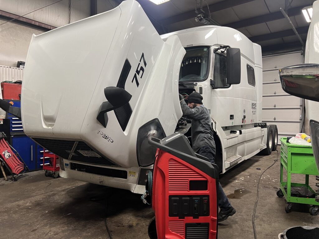 A/c Refringent on a Volvo VNL Semi Truck being drained and refilled