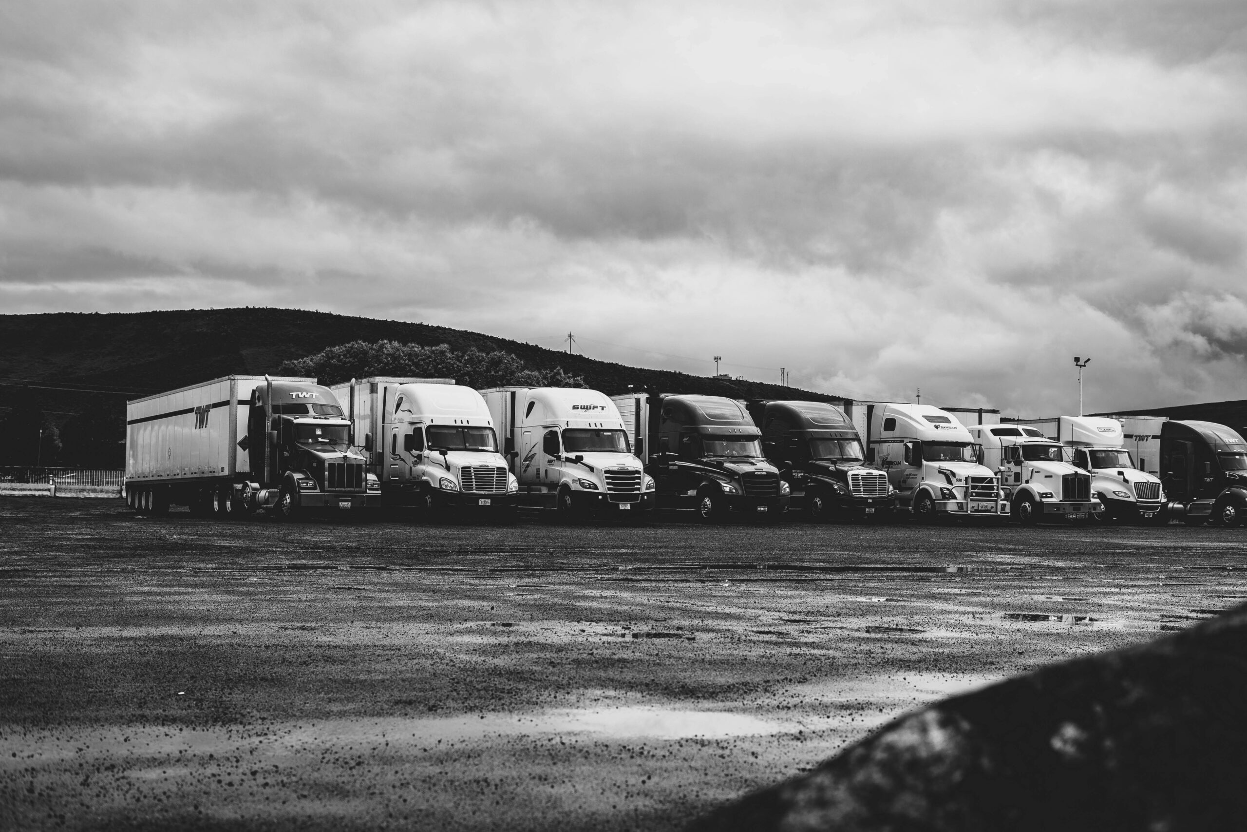 Semi truck and trailers lined up in a truck stop